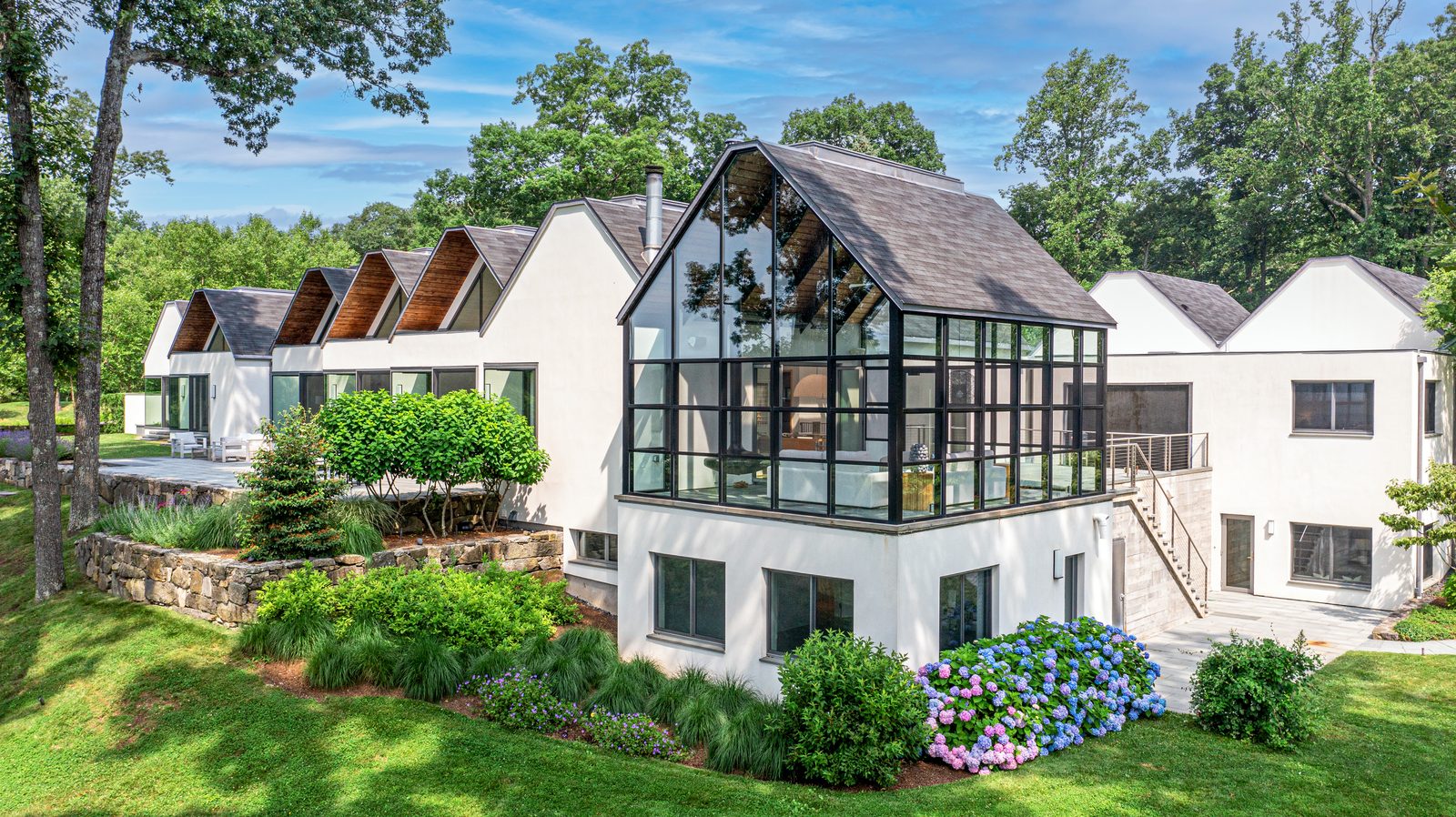 Exterior of a glass and stone residence in Weston, Connecticut