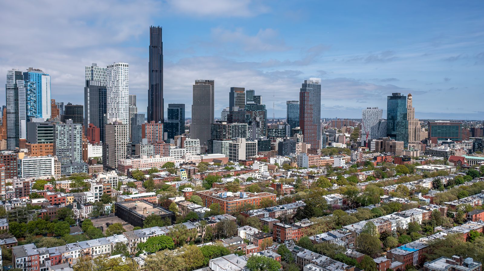 Aerial view over Brooklyn, New York, with the Manhattan skyline beyond